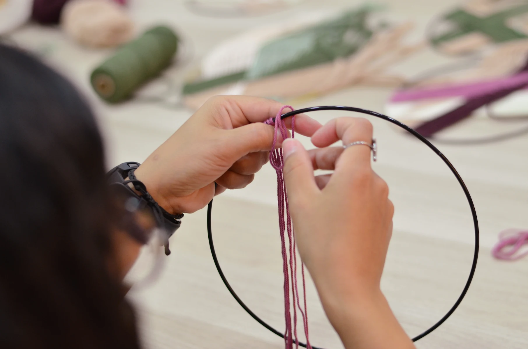 Participante elaborando un atrapa sueños de macramé